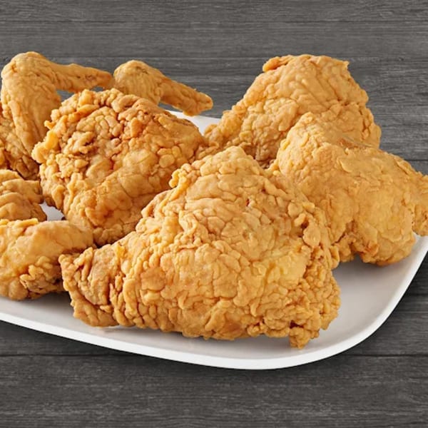 A white platter filled with golden-brown, crispy fried chicken pieces from Brown's Chicken.